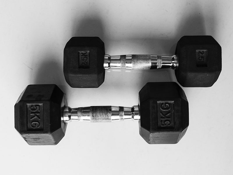Can You Bring Dumbbells on Planes? 1 A set of dumbbells on white background