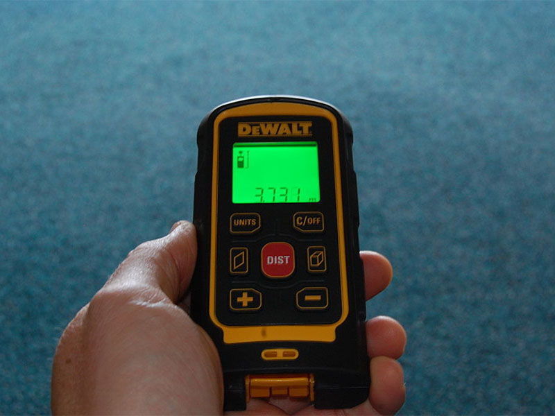 Can You Bring Laser Pointers and Other Laser Tools on Planes? 1 Electronic Laser measure held in hand