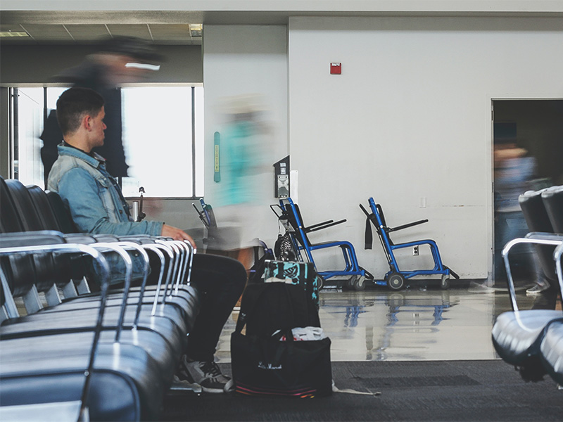 A man sitting inside and airport waiting for flight