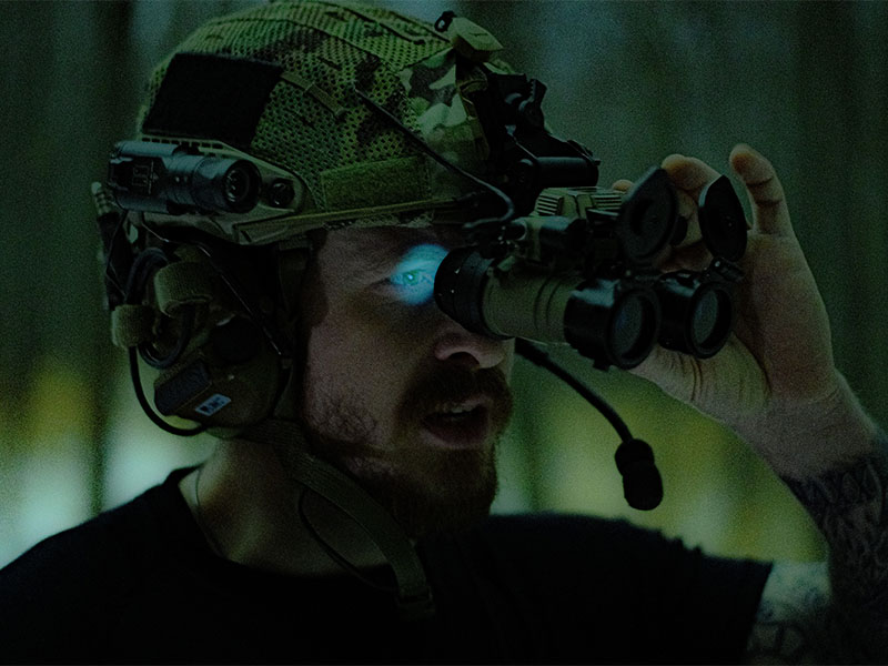 A man wearing night vision binoculars