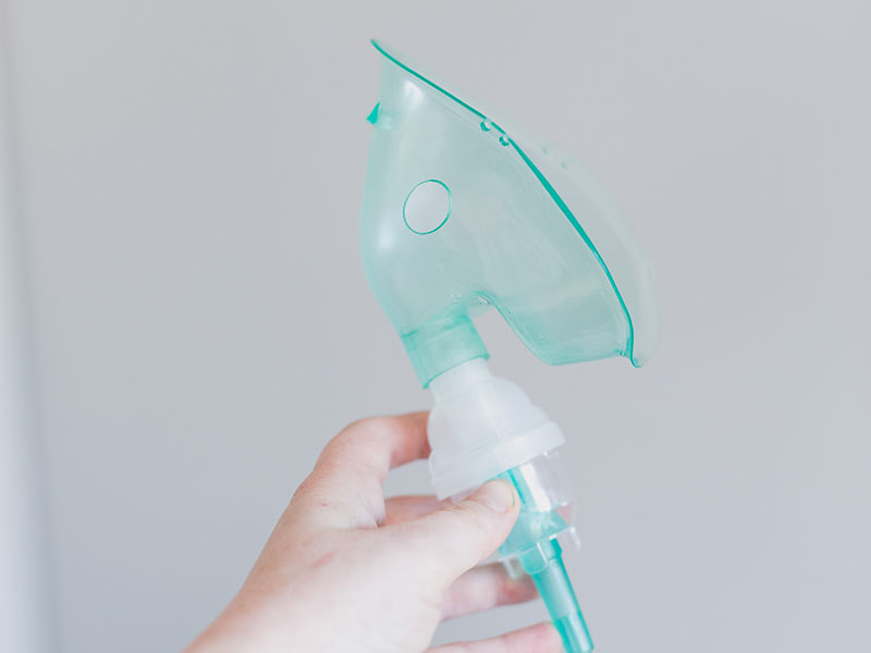Can You Bring Nebulizers on Planes? 1 Nebulizer inhaler tube held in hand